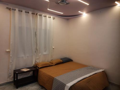 a bedroom with a bed in a room at Shriguru Guest House Akkalkot in Akalkot
