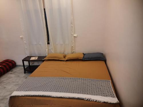 a bed in a small room with a window at Shriguru Guest House Akkalkot in Akalkot