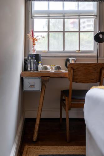 a wooden desk in a room with a window at The Pilot Inn in London