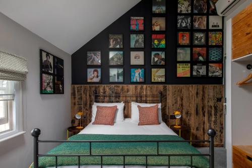 a bedroom with a bed and pictures on the wall at The Pilot Inn in London