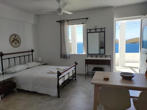 a bedroom with a bed and a table and a desk at Gialiskari Studios in Gialiskari