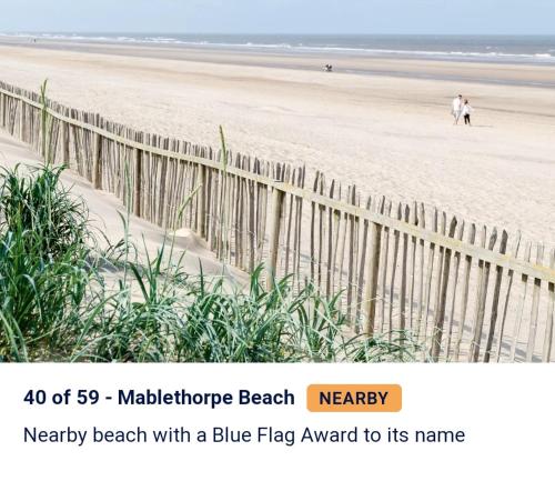 a tweet about a beach with a wooden fence at 3 bed caravan with decking dishwasher en suite Haven Golden Sands in Mablethorpe