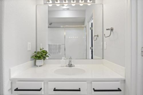 a white bathroom with a sink and a mirror at 151 Upper Monarch Cove 5E in Lake Ozark