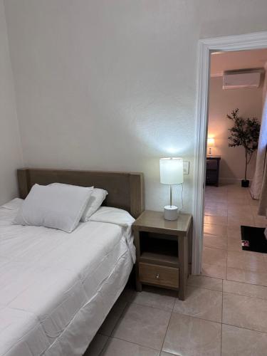 a bedroom with a bed and a table with a lamp at Hotel Mision Ferrer in San Vicente