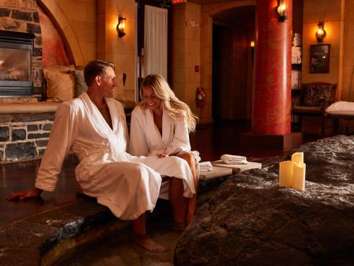 a man and a woman sitting on a bench at Mirbeau Inn & Spa - Skaneateles in Skaneateles