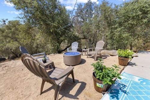 a patio with three chairs and a fire pit at Minutes from Sequoia Entrance in Three Rivers