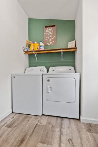 a laundry room with two dryers and a shelf at Minutes from Sequoia Entrance in Three Rivers