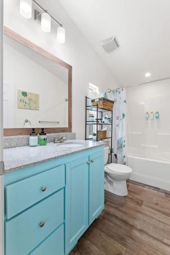 a bathroom with a blue sink and a toilet at Minutes from Sequoia Entrance in Three Rivers