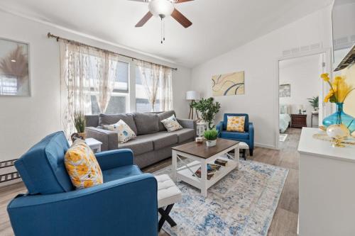a living room with blue chairs and a couch at Minutes from Sequoia Entrance in Three Rivers