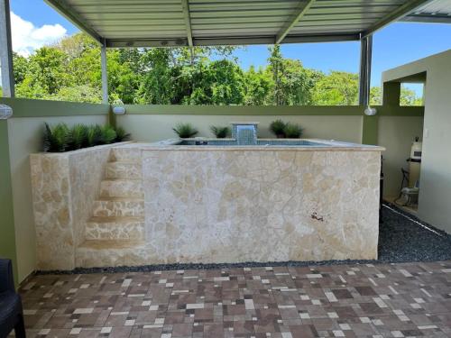 a stone counter in a patio with plants at Villa Carmin II Apartment with private pool in Caban