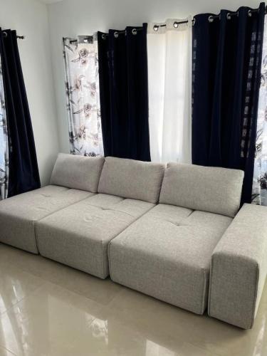 a couch in a living room with black curtains at Villa Carmin II Apartment with private pool in Caban