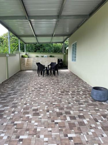 a patio with chairs and a table in a building at Villa Carmin II Apartment with private pool in Caban