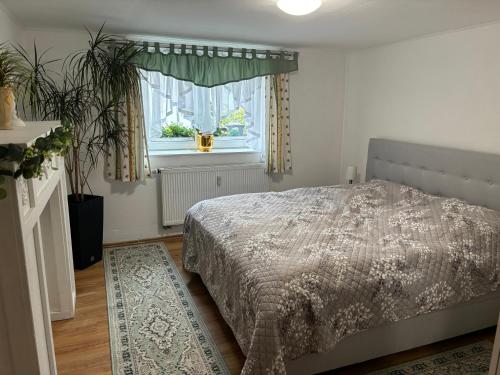 a bedroom with a bed and a window and a rug at EifelTörchen in Kirchheim