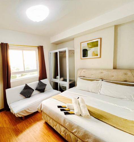 a bedroom with two beds and a window at Pool View Studio in Mesaverte with Free Pool & Netflix in Cagayan de Oro