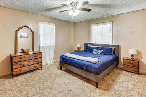 a bedroom with a bed and a dresser and a mirror at Rural Escape Near Lake Ouachita with Gas Grill! in Pearcy