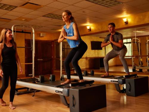 a group of people standing on a table in a gym at Mirbeau Inn & Spa - Skaneateles in Skaneateles