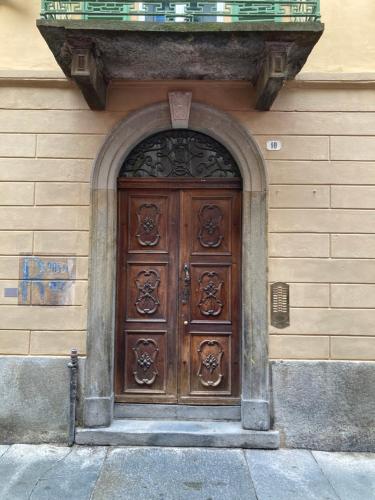 a large wooden door on the side of a building at La Corte in Alba