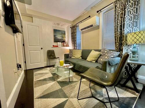 a living room with a couch and a table at Beautiful 3BR 3BA Duplex parking Best Location Boston in Boston