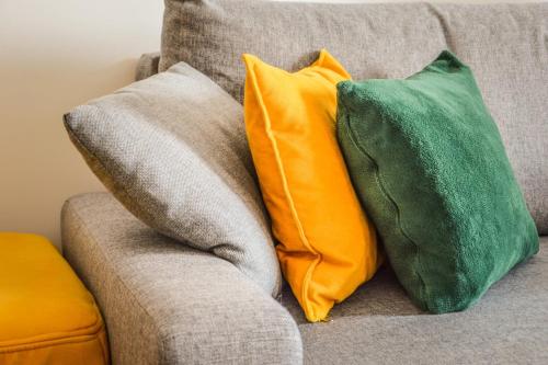 two yellow and green pillows on a couch at Apartman Ivice in Gornji Milanovac