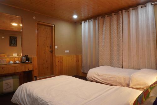 Postel nebo postele na pokoji v ubytování The Kaza Inn - Your mud house retreat