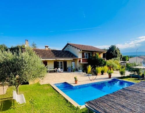 a house with a swimming pool in a yard at PierrAnge in Grillon