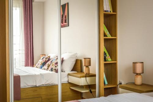 a bedroom with a bed and a book shelf at Apartman Ivice in Gornji Milanovac