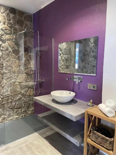 a bathroom with a sink and a glass shower at LOFT MORA - BENAOCAZ in Benaocaz