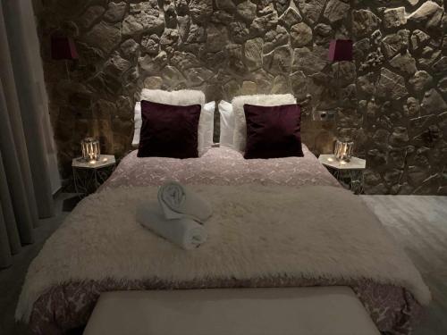 a bedroom with a large bed with towels on it at Loft mora - benaocaz in Benaocaz