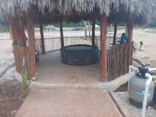 a wooden shelter with a barrel in the middle at Casa Nuevo Sol in Tesoco