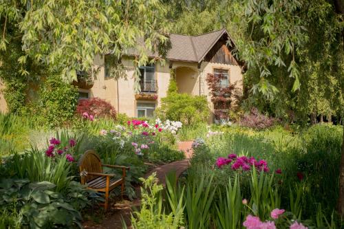 a garden in front of a house with flowers at Mirbeau Inn & Spa - Skaneateles in Skaneateles