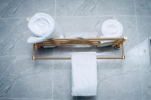 a towel rack in a bathroom with towels on it at Grand Palmac Hotel in Abuja