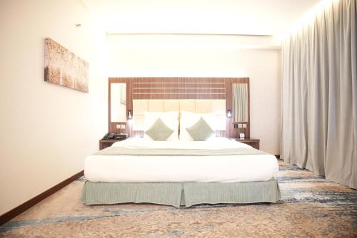 a bedroom with a large white bed in a room at White Diamond Hotel Sari in Jeddah