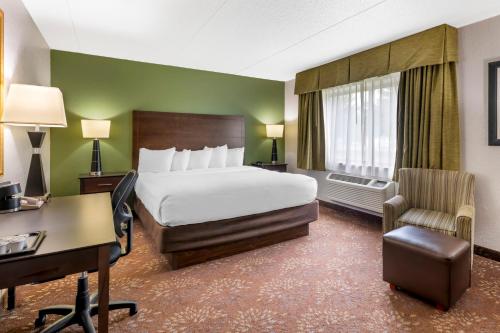 a hotel room with a bed and a desk and chair at Best Western Plus New Ulm in New Ulm