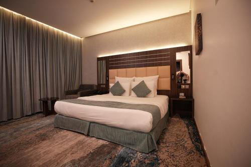 a bedroom with a large bed in a hotel room at White Diamond Hotel Sari in Jeddah