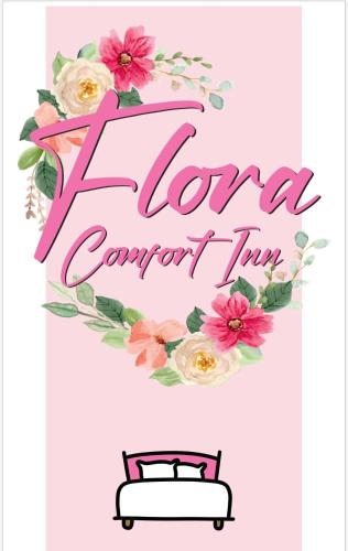 Ένα ή περισσότερα κρεβάτια σε δωμάτιο στο Flora Comfort Inn