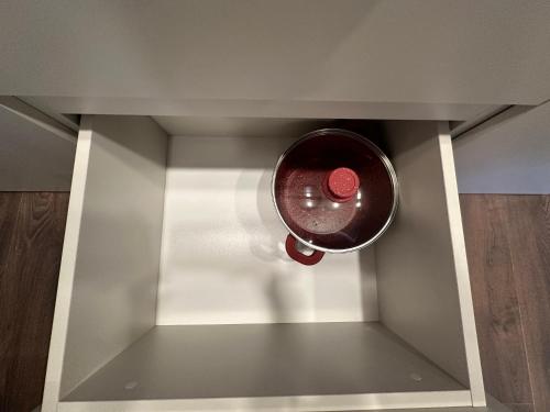 a red pot hanging from a wall in a kitchen at Business class studio with the Mountain View 115А in Batumi