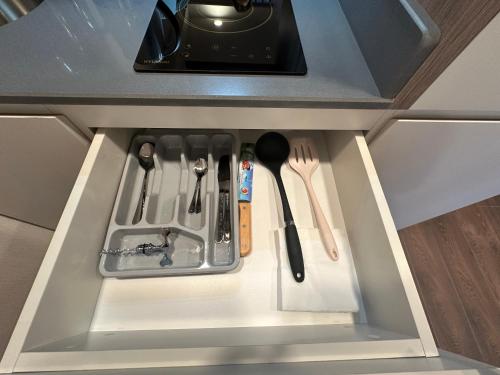 a drawer in a kitchen with utensils at Business class studio with the Mountain View 115А in Batumi