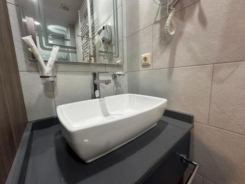 a white sink on a counter in a bathroom at Business class studio with the Mountain View 115А in Batumi
