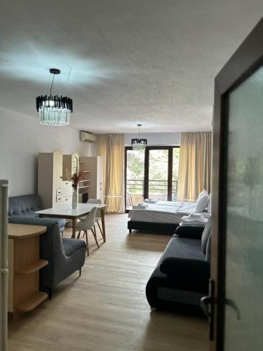 a living room with a bed and a table at Sandanski Apartments Park Center in Sandanski