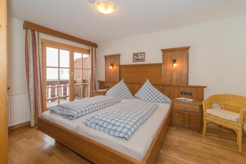a bedroom with a bed with blue and white pillows at Glösalm in Ramsau am Dachstein