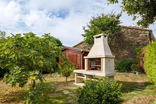 a bird house in the yard of a house at Adega in Ordes