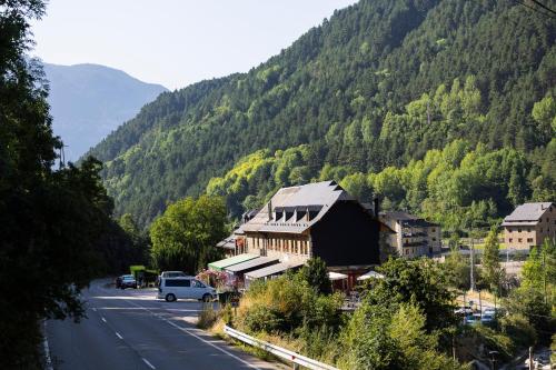 a small town on a road with a mountain at Hostal Pañart in Bielsa