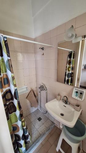 a bathroom with a sink and a toilet and a shower at Antzela Apartments in Sidari