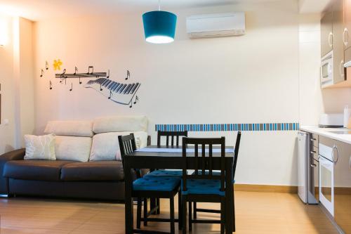 a living room with a table and chairs and a couch at Ronda Navarra by Valdesierra in Béjar