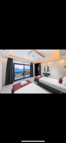 a bedroom with two beds and a view of the ocean at Villa simurg in Kas