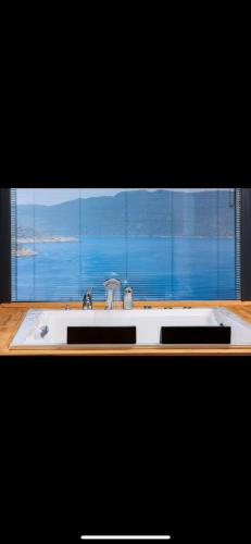 a bathroom sink with a view of a window at Villa simurg in Kas