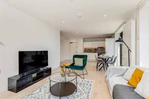 a living room with a couch and a table at Khayat Homes - The Riverre - Luxury 2 Bed Apt in London