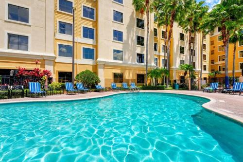 a swimming pool in front of a building at One bedroom unit near Epic Universe and Universal, free parking in Orlando