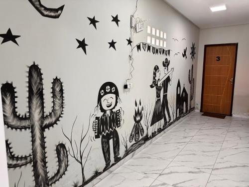 a hallway with a mural on the wall at Pousada Cangaço in Piranhas