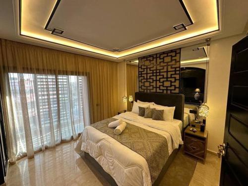 a bedroom with a large bed and a large mirror at Centre Zara 2BR in Marrakech